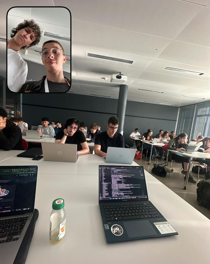 A room full of students at laptops, two laptops in front showing code; an inset shows two students taking a selfie.