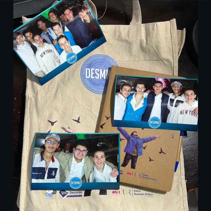 A DESMNU tote bag with printed photos of delegates laid on top.